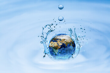 Planet Earth splashing in water surface on water, environment and save earth concept. Element of this image furnished by Nasa