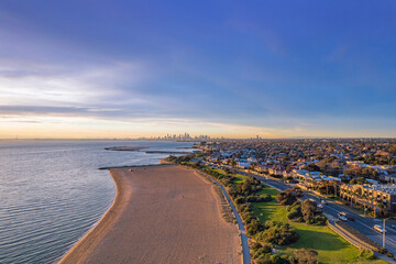 Aerial view of Brighton Beach in Melbourne, Australia. Melbourne skyline at sunset.