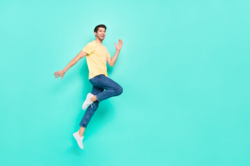 Fototapeta na wymiar Full size profile portrait of crazy cheerful man jump empty space isolated on teal color background
