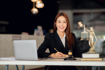 Attractive young lawyer in office Business woman and lawyers discussing contract papers with brass...