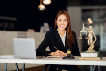 Attractive young lawyer in office Business woman and lawyers discussing contract papers with brass...
