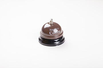 Service bell, ring for a coffee brown service bell on isolated white background, profil or side view photo. Service concept idea photo with copy space.