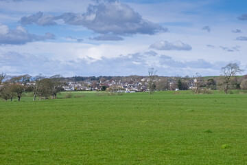 Obraz premium Looking over to the Town of Troon on the west coast of Scotland from Fullarton Woods with blue cloudy Skys 
