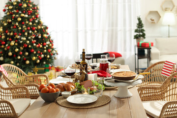 Festive dinner with delicious food and wine on table indoors. Christmas celebration