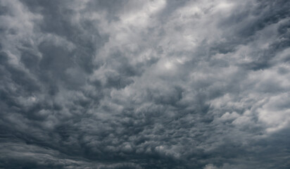 Dramatic rain storm clouds background. Light in Dark.