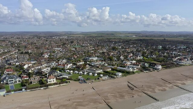 East Preston village Seafront and beach in West Sussex on the south coast of England with the South Downs in the background, Aerial Video.