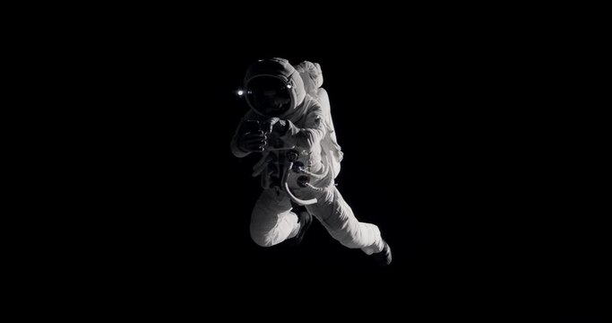 Caucasian female astronaut using her mobile phone during spacewalk, sending messages and taking pictures. Shot with 2x anamorphic lens