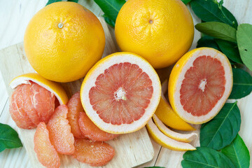 Fresh Grapefruit with leaves on Wooden background, Grapefruit or Yellow Pomelo on Wooden background.