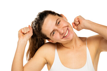 Naklejka premium Portrait of cheerful positive young woman with raised fists looking at camera isolated on white background