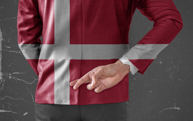 Businessman Jacket with Flag of Denmark with his fingers crossed behind his back