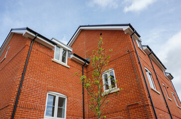 New build housing in UK. Exterior of newly built block of residential apartment flats in England. Housing market concept