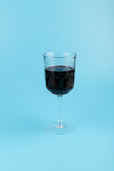 Port wine or fortified red wine  in a glass on blue background. copyspace.