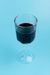 Port wine or fortified red wine  in a glass on blue background. copyspace.