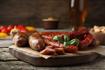 Set of different tasty snacks on wooden table, closeup view
