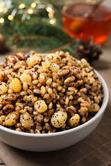 Traditional Christmas slavic dish kutia in bowl on napkin, closeup