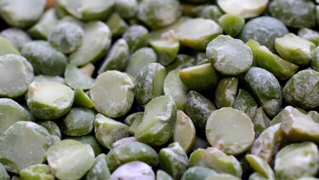 Pile of dried split green peas rotate slowly.