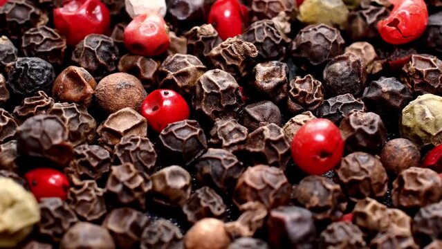 Pile of mixed dried multi colored peppercorns.