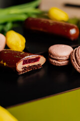 Beautiful mousse cakes covered with mirror shiny glaze. Green back ground. The skill of the pastry chef.