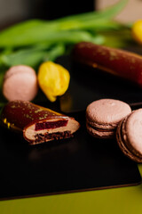 Beautiful mousse cakes covered with mirror shiny glaze. Green back ground. The skill of the pastry chef.