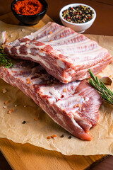 Raw ribs with rosemary on a wooden board