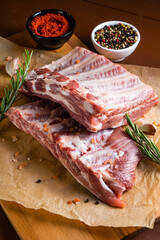 Raw ribs with rosemary on a wooden board