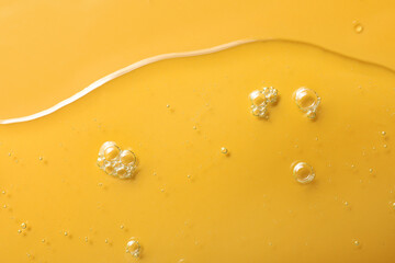 Sample of hydrophilic oil on orange background, top view