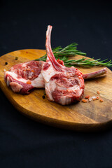 raw tomahawk with rosemary on a wooden board
