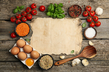 Parchment surrounded by different ingredients on wooden table, flat lay with space for text. Cooking classes
