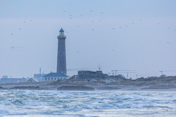 The lighthouse of Grenen at the most northern point of Denmark at sunset at a cold day in spring.