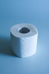 roll of white toilet paper on blue background