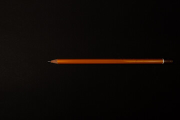 Orange pencil on a bright background