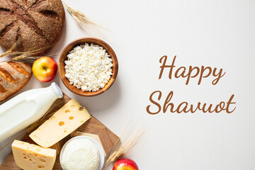 Happy Shavuot Jewish holiday greeting card, poster. Flat lay cottage cheese, bread, milk bottles,...