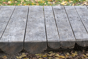 Old wooden table on green grass background