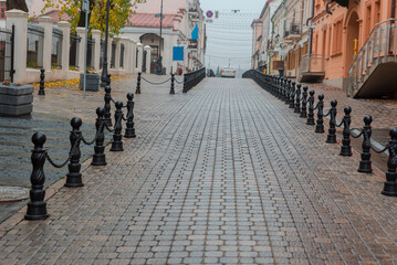 Fototapeta premium Close up of coble stone small and old street with building and sky