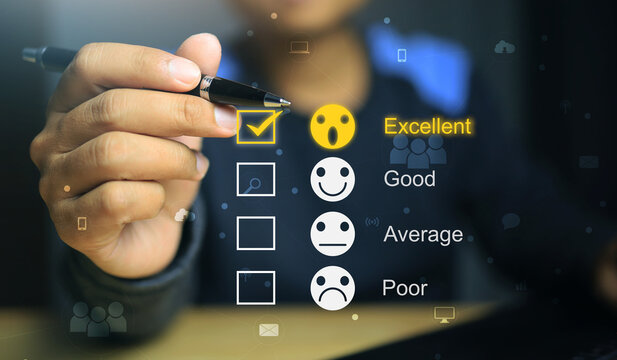 The men's hands holding the black pen were evaluating merchant services or online transactions with the highest score being Excellent out of four. - Powered by Adobe