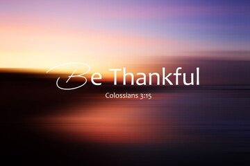 Bible verse inspirational quote - Be thankful. Colossians 3:15 On colorful abstract background illustration of blur sunrise sky over the sea. Grateful Christianity concept.