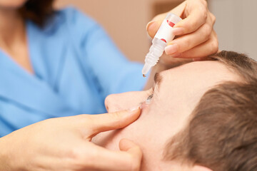 ophthalmologist medical patient. eyedrop apply. Eye clinic treatment. Hospital optics equipment....