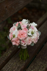 Pink wedding bouquet, composed of roses, freesias, peonies, hypericum, astilba and eucalypthus.