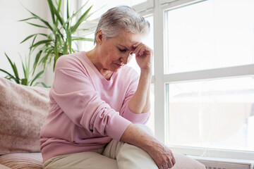 middle aged lady looking away sit alone at home feel anxious lonely, sad