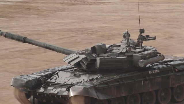 A Russian tank is moving at high speed around the landfill.