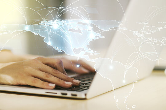 Double exposure of abstract digital world map with connections and hand typing on computer keyboard on background, big data and blockchain concept