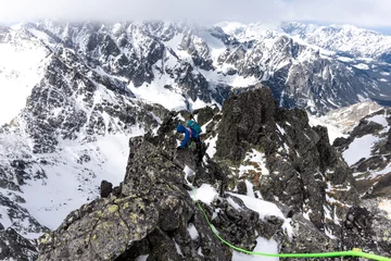 Papier Peint photo Himalaya Mountaineer climbing a granite ridge in High Tatras mountain national park, Slovakia
