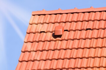 Detail of the new roof of the house with a gabled roof.Orange brick burnt roof tiles. Just laid on a wooden truss.
