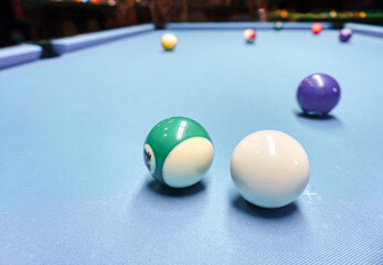 Billiards game - white and colorful balls on a table