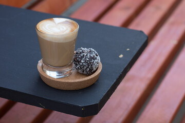 cup of coffee served with a cake ball