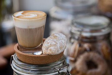 cup of coffee served with a biscuit 