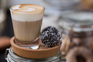 cup of coffee served with a cake ball
