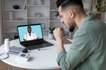 Telemedicine Concept. Ill Arab Man Having Video Call With Smiling Black Doctor