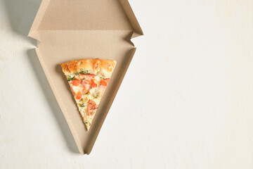 a slice of pizza in a triangle-shaped carton for serving and taking away