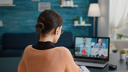 Female student talking on online class video call to study from home, attending teleconference meeting on webcam. Young woman learning knowledge on videoconference call discussion.